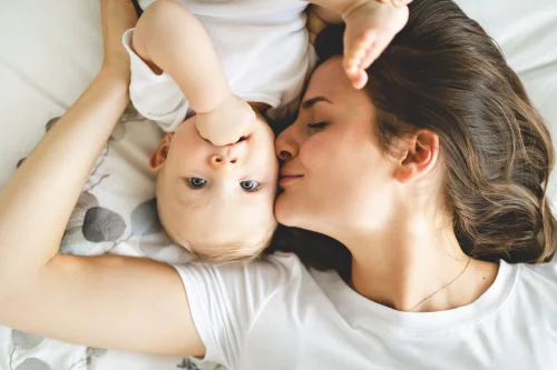 Mother kissing her baby