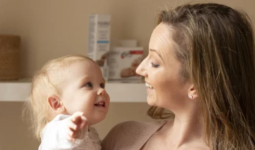 Mother and baby smiling at each other